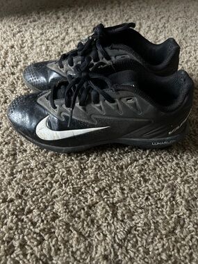 Kids Nike Black Athletic Cleats with White Swoosh